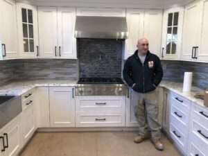 Man standing infront of renovated kitchen