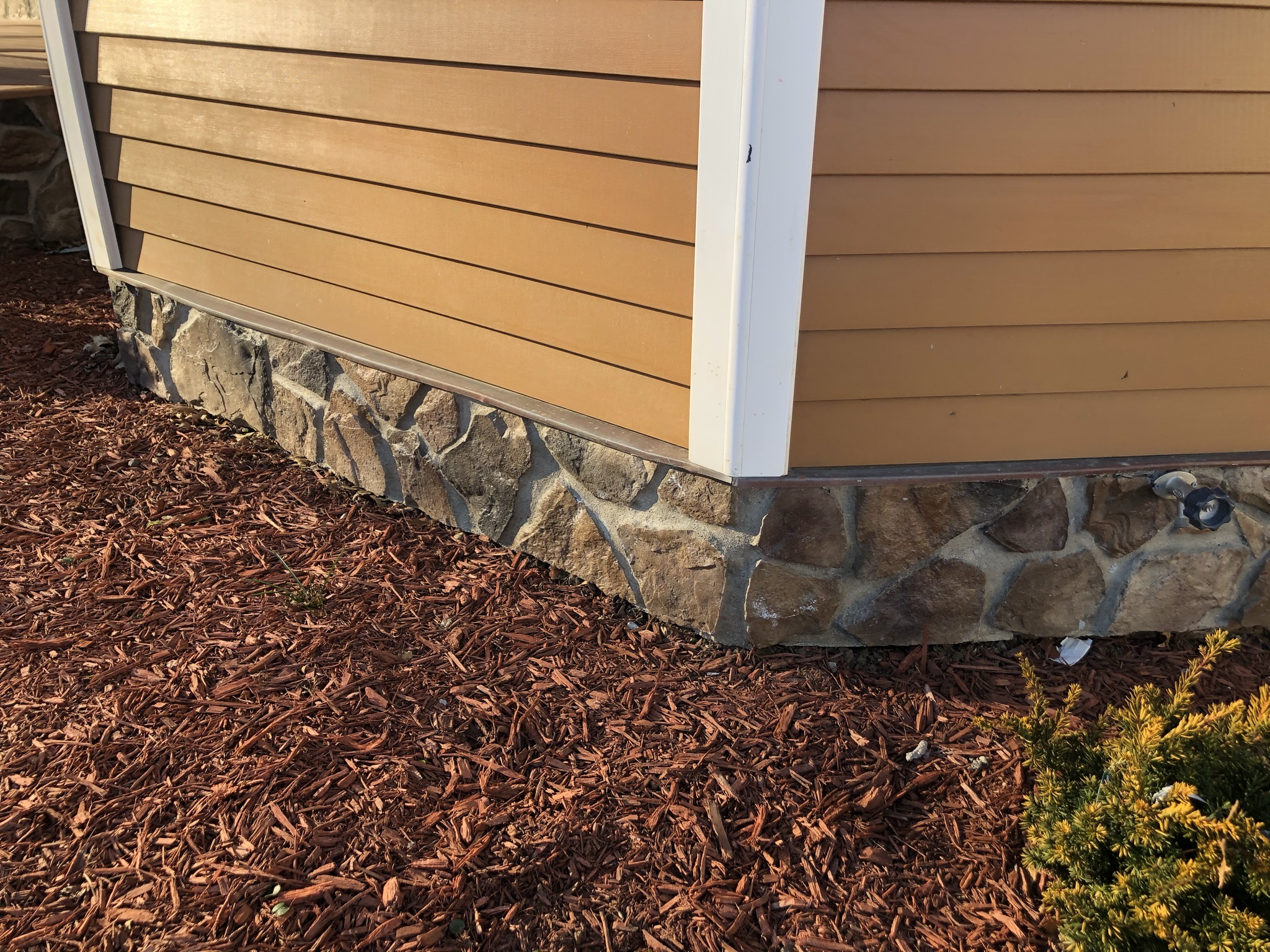 stone work bordering house